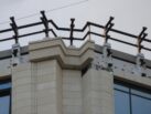 Готовый участок фасада жилого комплекса с установленным металлическим каркасом и смонтированными ограждениями